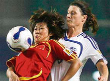 Chinas Han Dan (left) fights for the ball with Australias Cheryl Salisbury of World Stars team during a FIFA womens world stars match in Wuhan, in Chinas central province of Hubei.