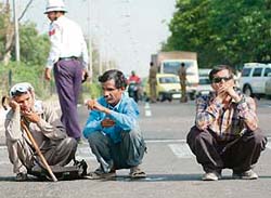 Members of the National Federation of the Blind, Haryana branch, block traffic at Madhya Marg on the road separating Sectors 9 and 17 in Chandigarh.