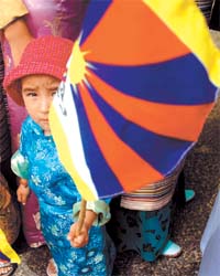Tibetan boy holds up his countrys flag during an anti-occupation rally in the Capital