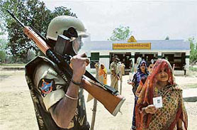 Villagers come out of a polling booth after casting votes in Barabanki district of Uttar Pradesh, on Monday.