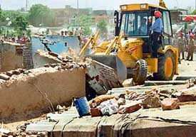Personnel of the GMADA demolish illegal structures in Lalbahadur Shastri Colony, Phase VI, Mohali, on Wednesday.