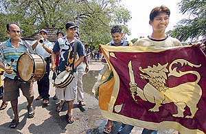 Sri Lankan cricket fans celebrate their teams win in the World Cup semifinal match against New Zealand, in the streets of Colombo, on Wednesday. 