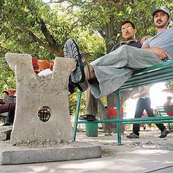Students at the students centre, Panjab University, use uprooted stone benches as foot rests while being perched on the newer metallic ones