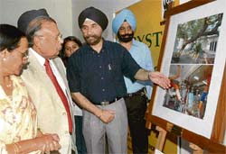 Punjab's Senior IAS officer D.S. Jaspal takes the Punjab and Haryana High Court Chief Justice Vijender Jain through his exhibition "Tryst with Trees inaugurated at the Lake Club in Chandigarh