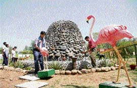 Girl students learning flower-making skills during special classes at Government Girls High School, Sector 25, Chandigarh; and (right) finishing touches being given to the newly built waterfall at Government Girls High School, Sector 25, Chandigarh.
