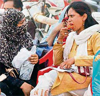 A polling officer enjoys an ice cream during preparations for the fifth phase of elections in Lucknow.