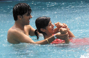 A couple tries to beat the heat in an Appu Ghar water feature in the Capital on Saturday. 