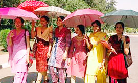Girls carry umbrellas to protect themselves from the sun in Patiala.