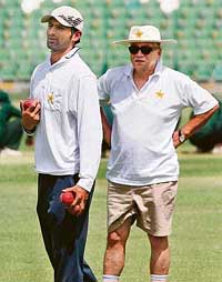 Pakistani cricket team manager Talat Ali (right) with newly appointed captain Shoaib Malik during a practice session at the Gaddafi Stadium in Lahore on Saturday. 