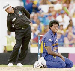 Sri Lankan bowler Dilhara Fernandos body language says it all as umpire Aleem Dar looks on during the World Cup final against Australia at the Kensington Oval in Bridgetown on Saturday. 