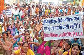 BJP activists carry dry pitchers to the Delhi Jal Board Headquarters in the Capital on Sunday. They are demanding the resignation of Delhi Chief Minster Sheila Dikshit and Delhi Jal Board chairman for failing to provide an adequate water supply.