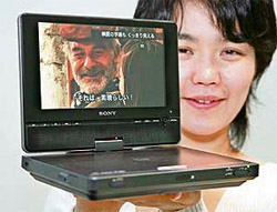 A Sony employee displays a new portable DVD player "DVP-FX850", equipped with a high-resolution 8-inch swivel and flip multi-angle LCD display, in Tokyo.