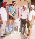 Hockey enthusiasts look at the statue of Olympian Surjit Singh at Mehdiana
