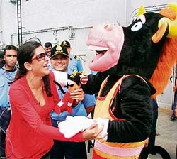Bravo, the mascot for World Military Games, greets actor Sushmita Sen onboard Indian Navys aircraft carrier INS Viraat off Mumbai.