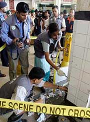 Bangladeshi police inspect an area hit by a bomb at Dhakas Kamalapur rail station on Tuesday. 
