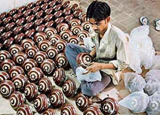 A worker packs fans at a factory in Amritsar.