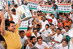 PYC workers protest the failure of the BJP-SAD government in providing cheap atta-dal in Jalandhar on Wednesday