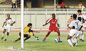 JCT striker Edeh Chidi is about to score the match winner against Mahindra United, Mumbai, in the 11th National Football League at Ludhianas Guru Nanak Stadium on Wednesday.
