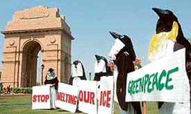Greenpeace activists dressed as penguins stage a protest near India Gate in New Delhi on Thursday. The activists were protesting against global warming and the melting of polar ice caps. 