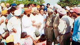 DSP Rajinderpal Anand asks the protesters at Bhadson village to lift blockade.
