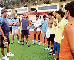 Indian hockey coach Joaquim Carvalho (left) talks to the players on the eve of their opening match of the Sultan Azlan Shah tournament in Kuala Lumpur.
