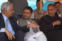 Former Chief Minister and PDP patron Mufti Mohammad Sayeed (left) shares a point with a party leader at a rally at Srigufwara in Anantnag district on Saturday.