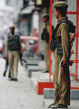 Security forces jawans stand guard during a strike in Srinagar on Saturday.