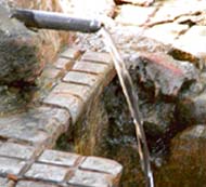 A water tap runs unattended even as the MC cries the save water slogan