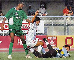 JCT striker Parveen Kumar (centre) is sandwiched between HAL defender Joseph Femi Adeola and goalkeeper Gumpe Rime during a match of the 11th National Football League at Ludhianas Guru Nanak Stadium on Saturday.