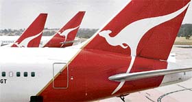 Qantas planes sit at a gate at Melbournes Tullamarine Airport. Australian regulators on Sunday blocked a private equity consortiums multi-billion dollar takeover bid for Qantas Airways