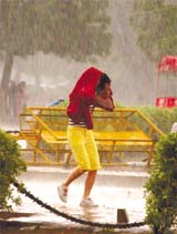 A girl caught in rain near the India Gate in the Capital on Sunday afternoon