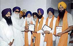 Professor Kirpal Singh Badungar and others receive mementos in Ahmedgarh on Saturday