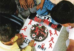 An HIV positive child cuts a cake at International Hostel, Sector 15, Chandigarh, on World AIDS Orphans Day
