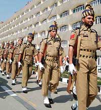 Police jawans take part in a ceremony marking the first day of the durbar move outside the Civil Secretariat complex in Srinagar on Monday.