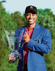 Tiger Woods poses with the winners trophy after his victory at the Wachovia championship in Charlotte, North Carolina on Sunday. 