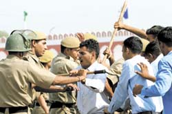 Delhi Police personnel show their skills in handling a law and order situation at the passing out parade of 78th batch of Police Training College at Jharoda K