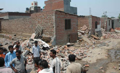 Rubble of the dairy sheds demolished by the municipal corporation at Ram Nagar in Birring, near Jalandhar, on Tuesday.