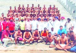 Kabaddi trial participants pose with the selectors at Parasrampur village