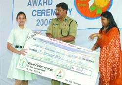 Mannat Sohi, a class VI student of Delhi Public School, receives a cheque for Rs 6,000 from SSP Arpit Shukla.