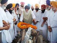 Punjab Chief Minister Parkash Singh lays a wreath on the body of Kirpal Singh Libra, former MLA and senior SAD(B) leader at his cremation at Libra village in Ludhiana district on Tuesday