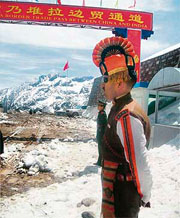 Personnel of Indo-Tibetan Border Police (ITBP) (right) and People Liberation Army (PLA) of China stand guard on either side of the Indo-China border Nathu La pass.