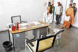 Patients await the arrival of the doctor at the government dispensary of Dadu Majra colony
