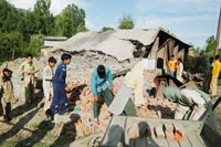 Childern near the house which was destroyed during an encounter between the security men and militants in Srinagar