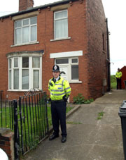 British police officers guard the entrance to an address in Pentland Road, in Dewsbury, West Yorkshire, in northern England on Wednesday, following the arrests of four persons under the Terrorism Act 2000.