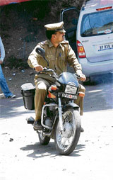 This policeman was clicked in the state capital driving a motor cycle without wearing a helmet mandatory under the Motor Vehicles Act.
