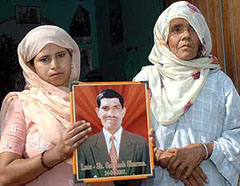 Lachhmi Devi (left), widow of Subhash, with Shanti Devi (mother) holding a photograph of the deceased at their residence in Karnal on Thursday.
