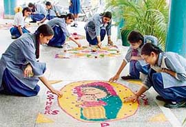 students five finishing touches to their Rangoli creations at GMT School in Ludhiana
