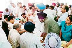 MunicipaL Corporation officials listen to grievances of residents at a sangat darshan programme in Ludhiana 