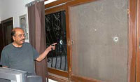 Pakistani lawyer Munir Malik shows bullet marks at his residence on Thursday, in Karachi.