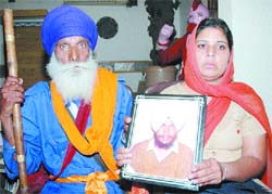 Father and wife of Sukhpal Singh of Kala Afghana village, who was killed by the Punjab police in fake encounter in 1994, in Amritsar.